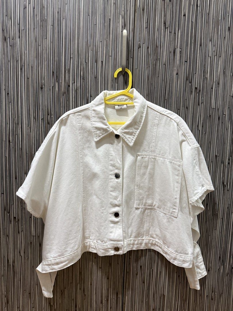 BOCU White Denim Cropped Shirt (Category: Shirts) located in Pasig City. Submitted by rizzzzahh (Listing ID 1464275631, Image 1). Description: BOCU White cropped denim shirt Size on Tag: S/M Fits Medium to Large - Versatile for layering or wearing alone Excellent Condition Used once only RFS: Decluttering Closet.