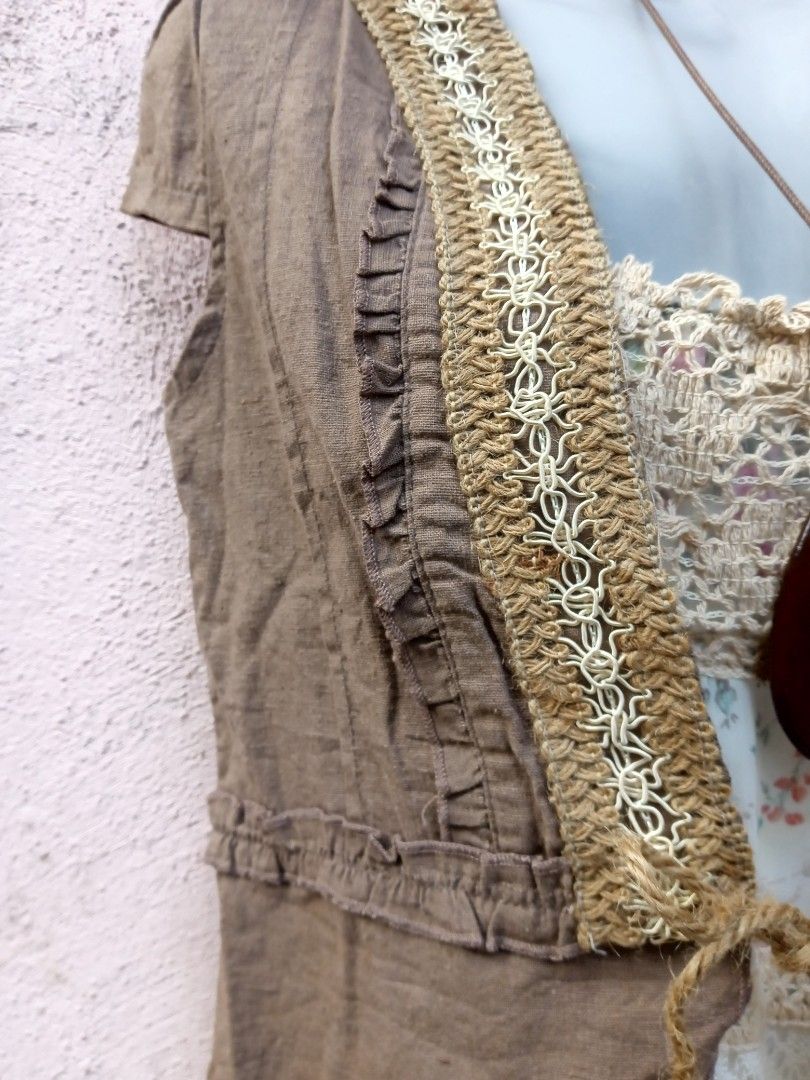 Boho Crochet Trimmed Vest (Category: Dresses) located in Placer. Submitted by whimsythrifts (Listing ID 1464190935, Image 2). Description: - Cute boho-inspired outfit - Brown vest with crochet trim and ruffled details - Vest features short sleeves and front ties - Layered over a white floral and lace dress - Ideal for a relaxed, stylish look - Necklace shown is not included +sf.