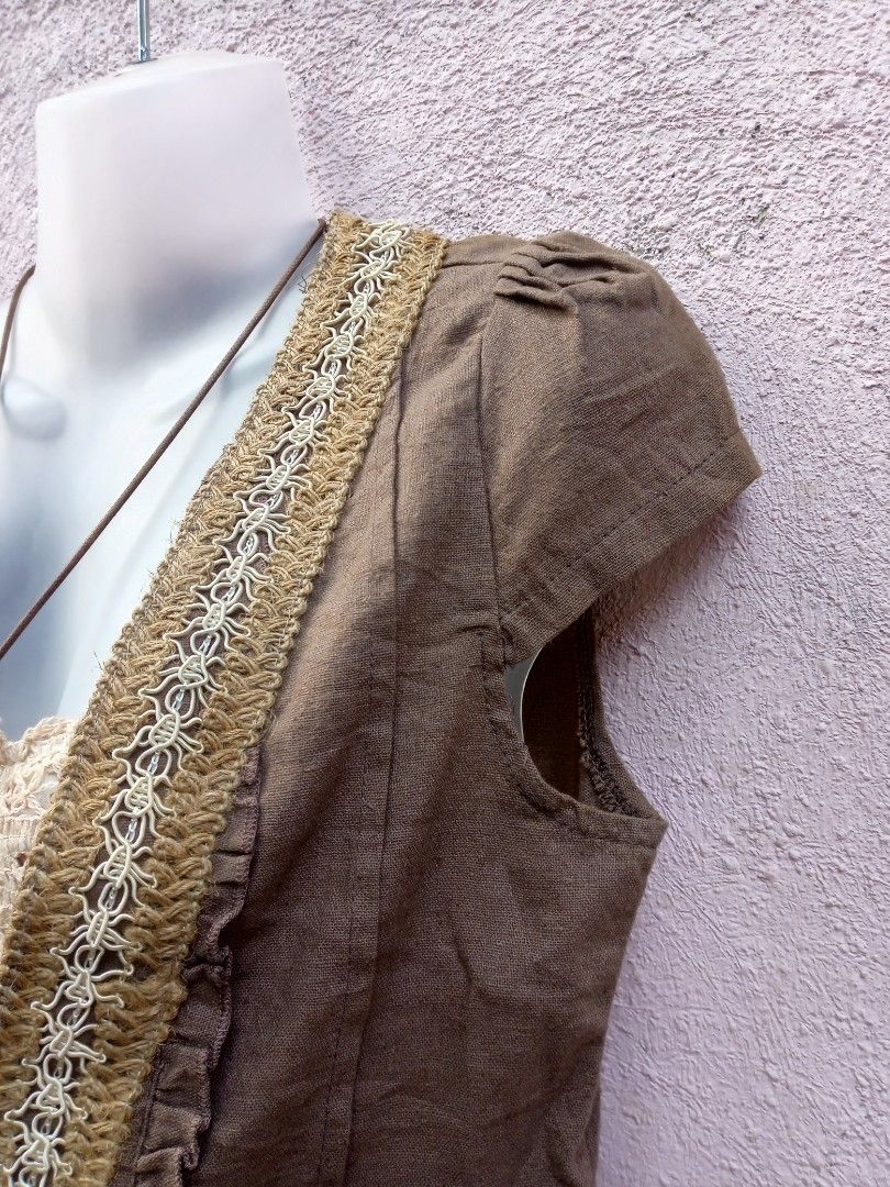 Boho Crochet Trimmed Vest (Category: Dresses) located in Placer. Submitted by whimsythrifts (Listing ID 1464190935, Image 3). Description: - Cute boho-inspired outfit - Brown vest with crochet trim and ruffled details - Vest features short sleeves and front ties - Layered over a white floral and lace dress - Ideal for a relaxed, stylish look - Necklace shown is not included +sf.