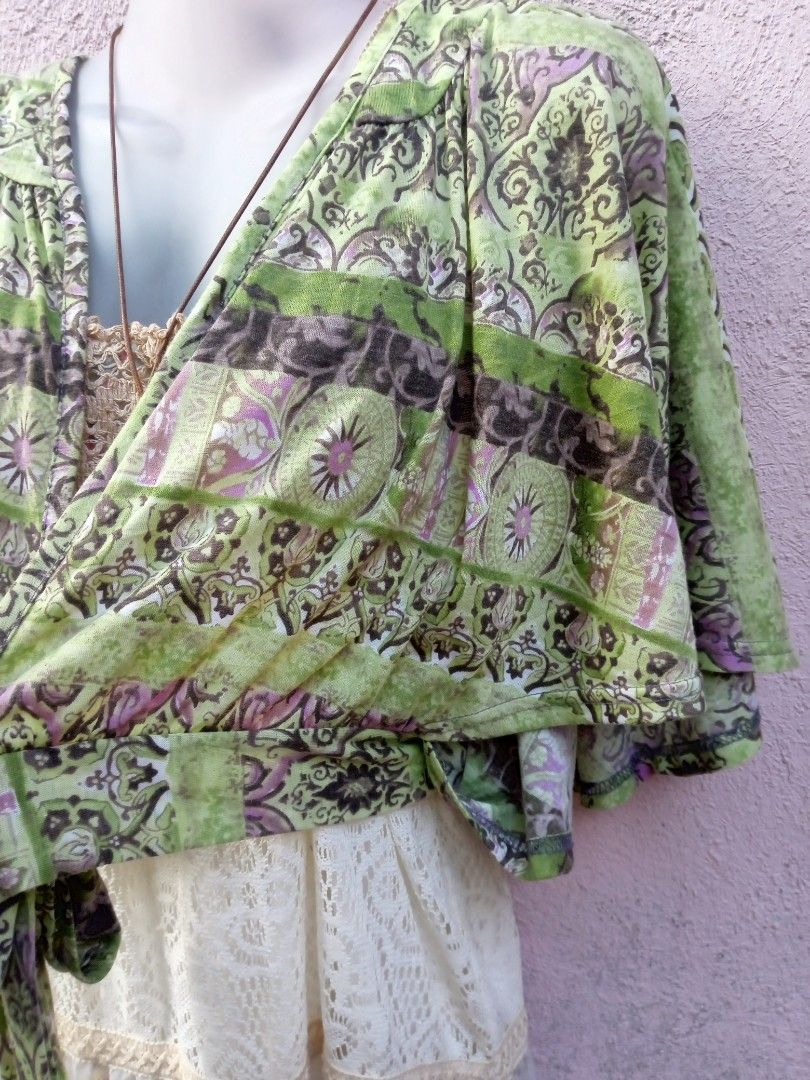 Boho Green Patterned Kimono Cardigan with Tie Front (Category: Coats, Jackets and Outerwear) located in Placer. Submitted by whimsythrifts (Listing ID 1464204497, Image 3). Description: - Lightweight kimono-style cardigan - Vibrant green and purple bohemian print - Short, fluttery sleeves - Ties at the front - Ideal for casual, free-spirited layering over dresses or tops +sf.