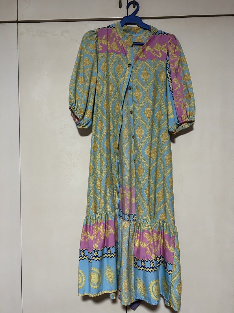 Boho Print Button-Up Maxi Dress with Ruffle Hem (Category: Dresses) located in Makati City. Submitted by monicavazquez (Listing ID 1464250329, Image 1). Description: - Light blue maxi dress - Bold gold and pink print - Puff sleeves with elastic cuffs - Button-up front - Tiered ruffle hem design - Ideal for casual wear or vacation - Comfortable and easy to wear.