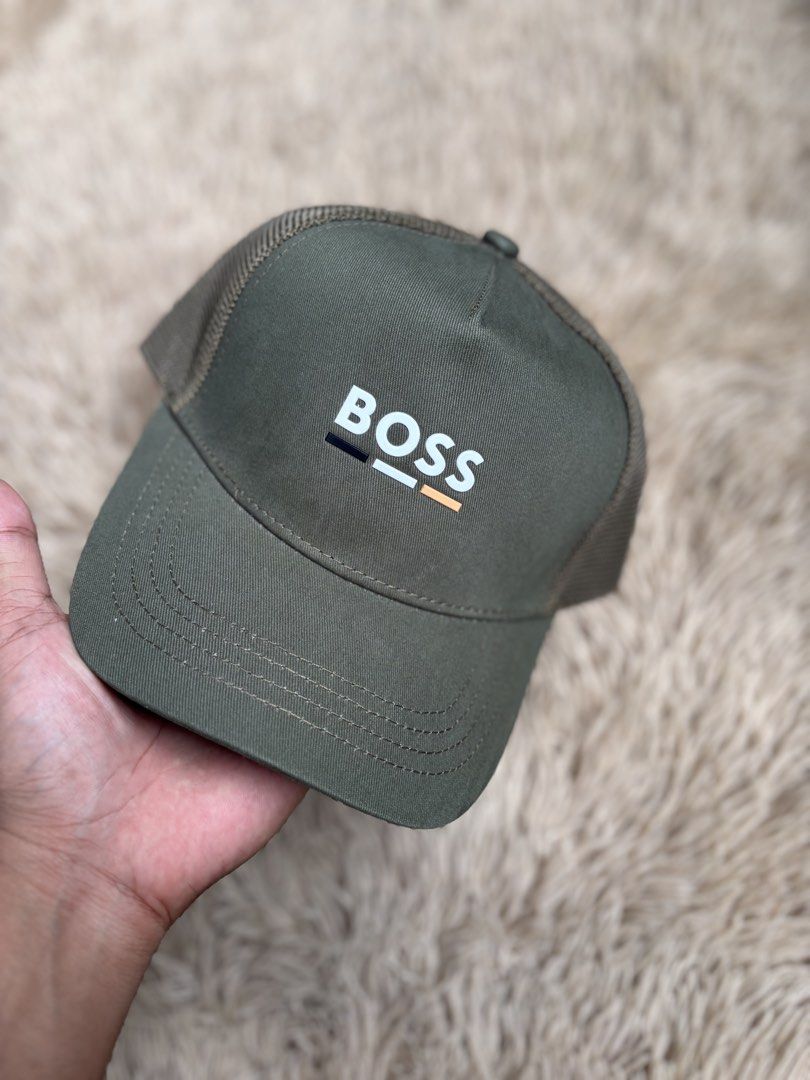 BOSS Cap Green Mesh Trucker Hat (Category: Caps & Hats) located in Quezon City. Submitted by nojthrift (Listing ID 1464252010, Image 2). Description: - Green BOSS trucker cap - Prominent BOSS logo on the front - Breathable mesh back for comfort - Adjustable strap for a customized fit - Ideal for everyday casual wear.