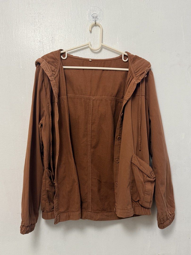 Brown Hooded Button-Up Jacket with Pockets (Category: Coats, Jackets and Outerwear) located in Mandaluyong City. Submitted by nftp24 (Listing ID 1464220561, Image 3). Description: - Brown hooded jacket - Button-up front - Two front pockets - Elasticated cuffs and hem - Drawstrings on the hood - Small dark mark on the front (visible in the last photo).