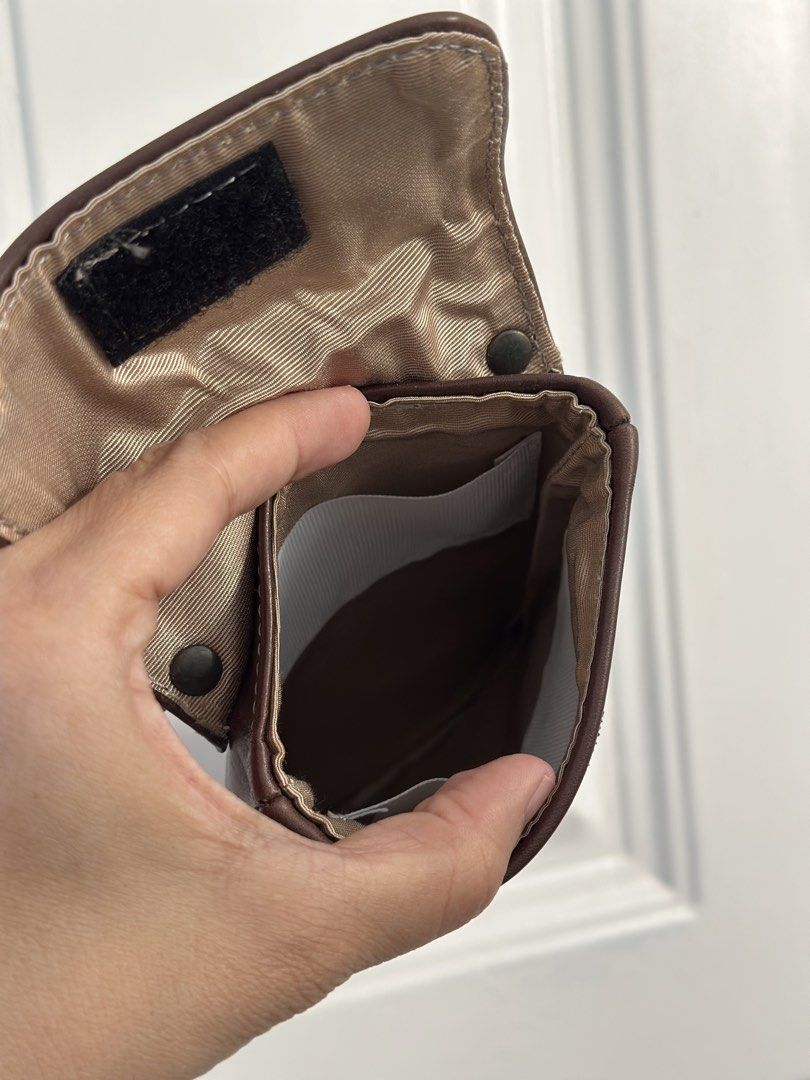 Brown Leather Pouch with Belt Loop and Card Slots (Category: Luxury Bags & Wallets) located in Batangas. Submitted by enyahsnivl56498 (Listing ID 1464189942, Image 3). Description: - Brown leather pouch - Belt loop on the back for easy carrying - Interior slots - Secure velcro strap closure - Perfect for keeping small essentials accessible - Phone pouch - Approximate dimensions: 6 inches tall x 3.5 inches wide Kasya ang PROMAX na iphone .
