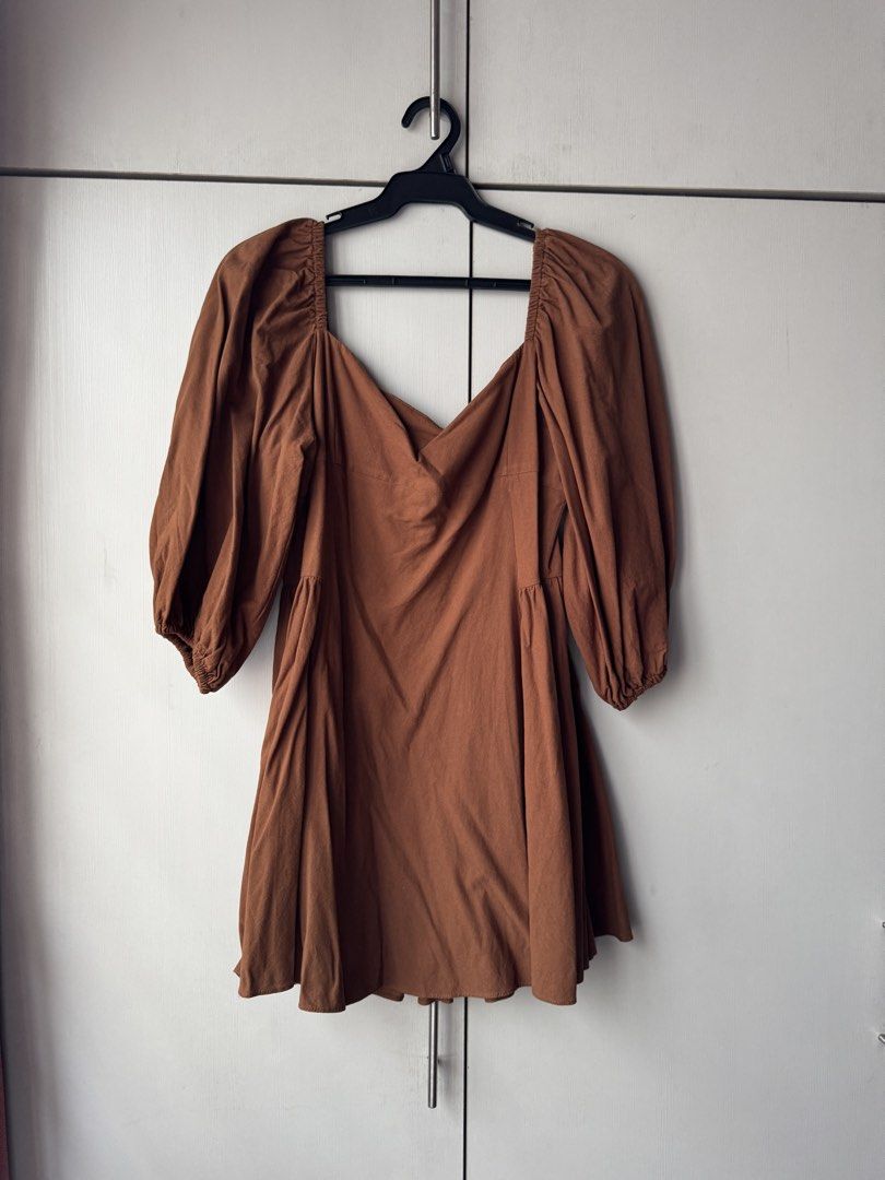 Brown Puff Sleeve Square Neck Mini Dress (Category: Dresses) located in Quezon City. Submitted by jrc_98 (Listing ID 1464199401, Image 1). Description: - Cute brown mini dress - Puff sleeves - Square neckline with ruching detail - Flattering A-line skirt - Versatile for casual outings or dressing up - Easy to wear and style.