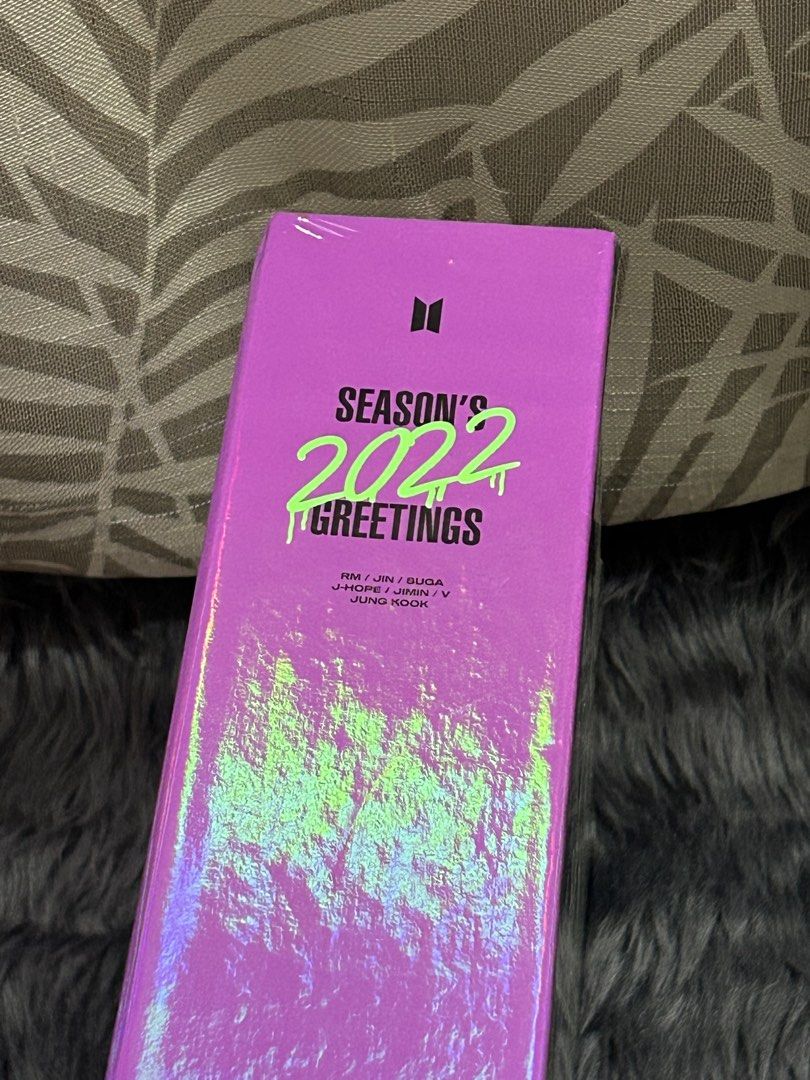 BTS 2022 Season's Greetings Box Set (Category: K-Wave Merchandise) located in Cabiao. Submitted by hoardercanthelpit (Listing ID 1464210917, Image 2). Description: - Official BTS 2022 Season's Greetings box - Features all 7 members: RM, Jin, Suga, J-Hope, Jimin, V, Jungkook - Eye-catching holographic purple and green packaging - Perfect addition to any ARMY's collection - Authentic BTS merchandise plus calendar posters.