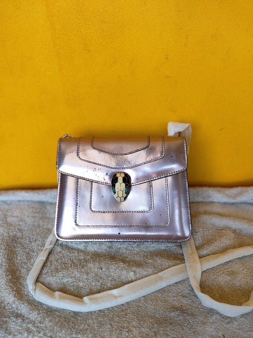 Bulgari Serpenti Shoulder Bag Pink Metallic (Category: Luxury Bags & Wallets) located in Cebu City. Submitted by cherreymie70208 (Listing ID 1464154208, Image 1). Description: - Eye-catching pink metallic shoulder bag - Features the signature Bulgari snake head detail - Comes with a stylish chain strap - Interior serial number tag for authenticity - Minor marks on the exterior, adding character - Perfect statement piece to elevate any outfit.