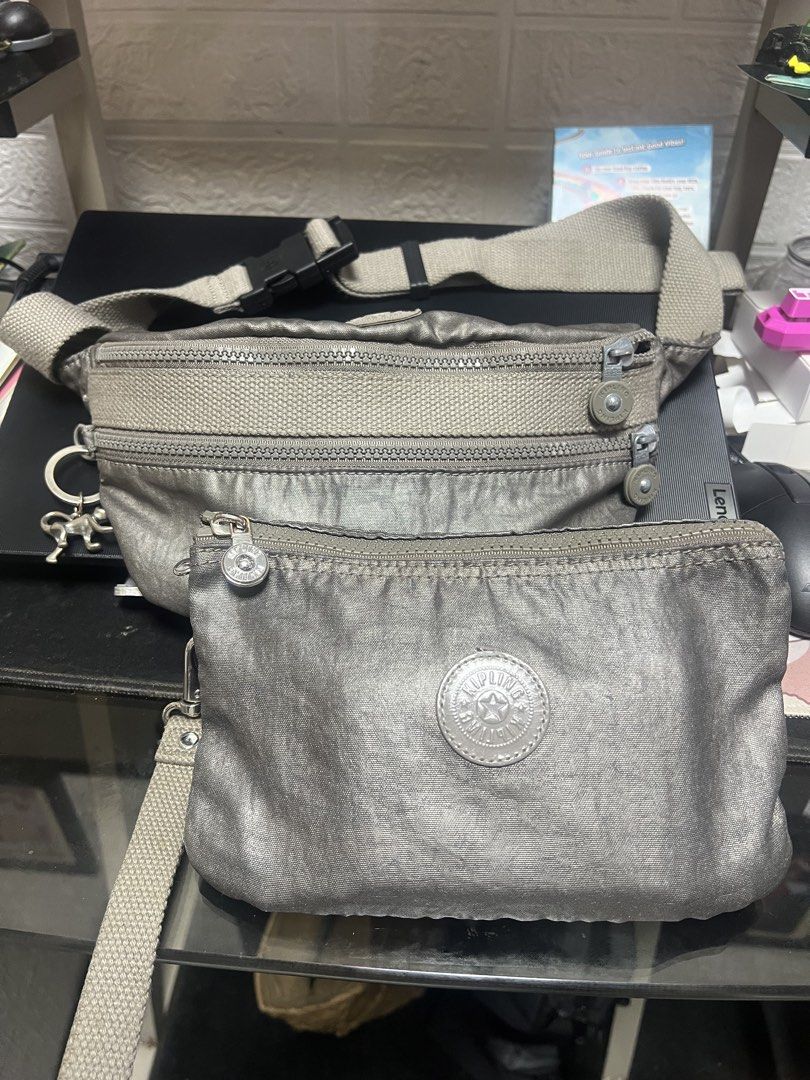 Bundle Kipling Metallic Grey Waist Bag with Pouch (Category: Cross-body Bags) located in General Trias. Submitted by mybag2025 (Listing ID 1464291080, Image 1). Description: - Metallic grey Kipling waist bag - Includes a matching detachable pouch - Adjustable strap with a secure buckle closure - Features the iconic Kipling monkey charm - Ideal for travel or everyday use - Ample space for your essentials.