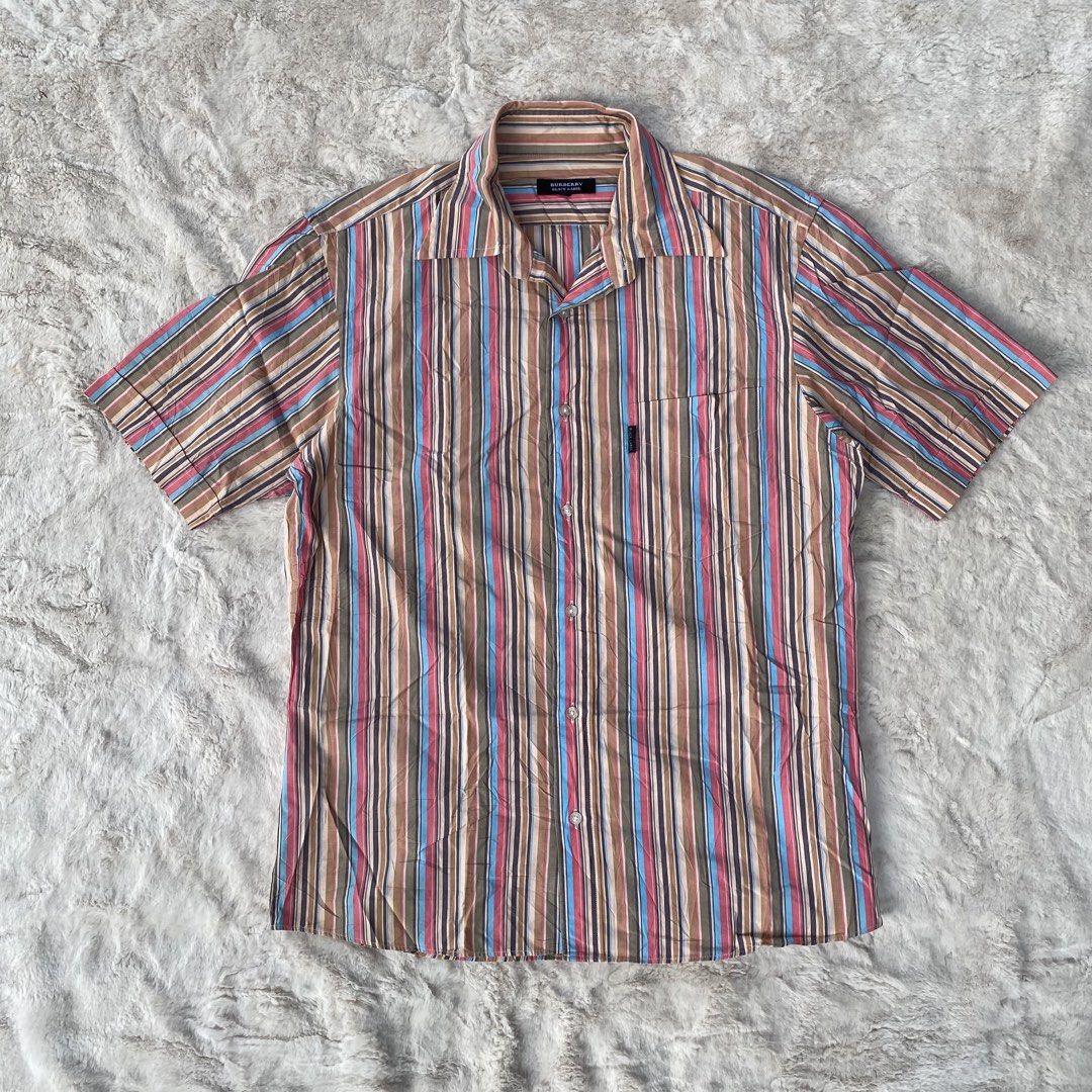BURBERRY BLACK LABEL BUTTON DOWN SHORT SLEEVE POLO AUTHENTIC (Category: Luxury Apparel) located in Cadiz. Submitted by thrift_hunt_garage (Listing ID 1464278162, Image 1). Description: BURBERRY BLACK LABEL BUTTON DOWN SHORT SLEEVE POLO AUTHENTIC Size and measurements by inches : On tag 2 Width 21 Length 27 Conditions and details Cotton material Vertical colored stripe Issue none Flaws none.