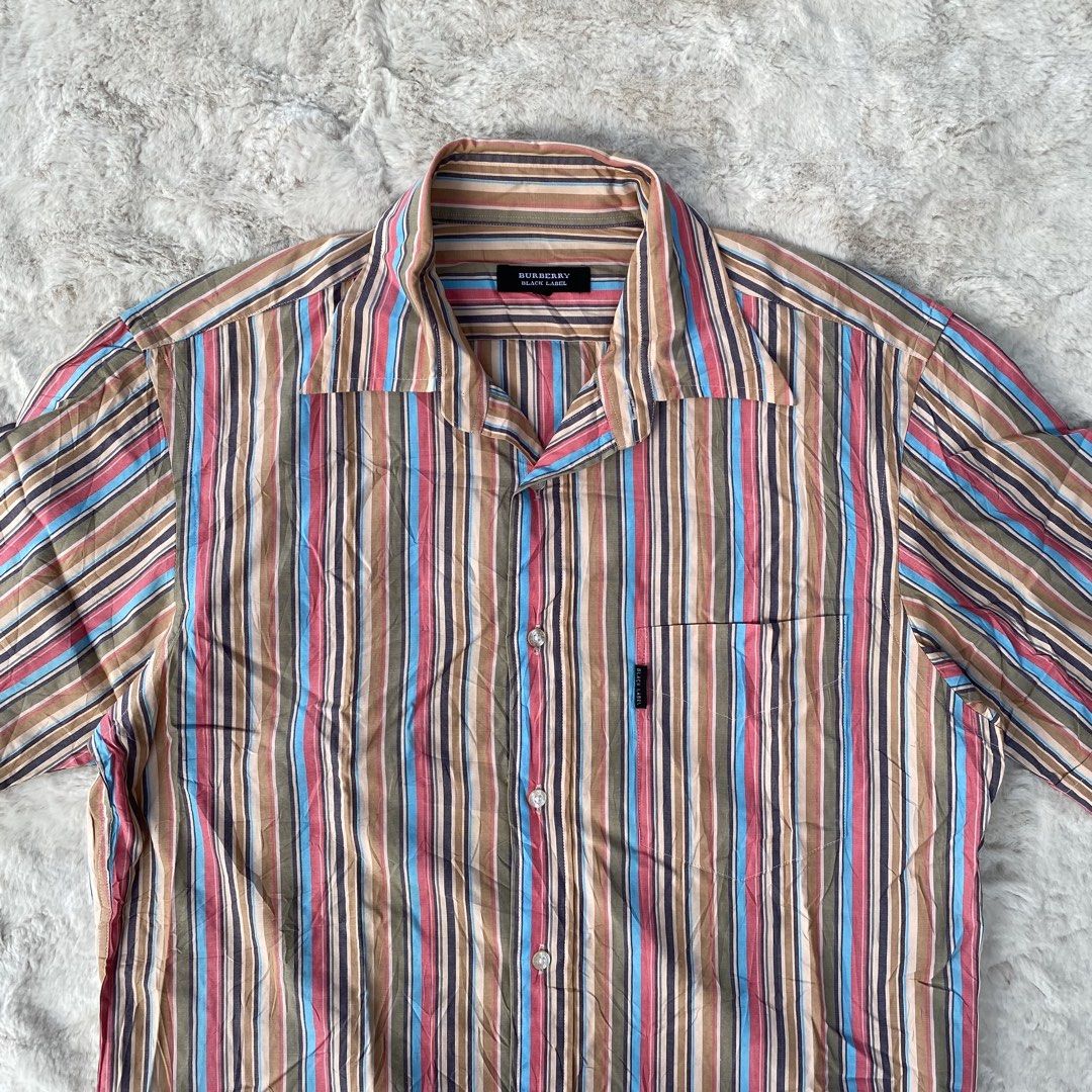 BURBERRY BLACK LABEL BUTTON DOWN SHORT SLEEVE POLO AUTHENTIC (Category: Luxury Apparel) located in Cadiz. Submitted by thrift_hunt_garage (Listing ID 1464278162, Image 2). Description: BURBERRY BLACK LABEL BUTTON DOWN SHORT SLEEVE POLO AUTHENTIC Size and measurements by inches : On tag 2 Width 21 Length 27 Conditions and details Cotton material Vertical colored stripe Issue none Flaws none.