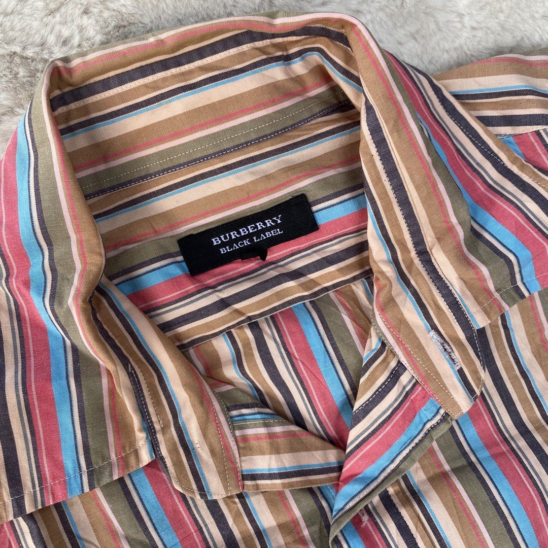 BURBERRY BLACK LABEL BUTTON DOWN SHORT SLEEVE POLO AUTHENTIC (Category: Luxury Apparel) located in Cadiz. Submitted by thrift_hunt_garage (Listing ID 1464278162, Image 3). Description: BURBERRY BLACK LABEL BUTTON DOWN SHORT SLEEVE POLO AUTHENTIC Size and measurements by inches : On tag 2 Width 21 Length 27 Conditions and details Cotton material Vertical colored stripe Issue none Flaws none.