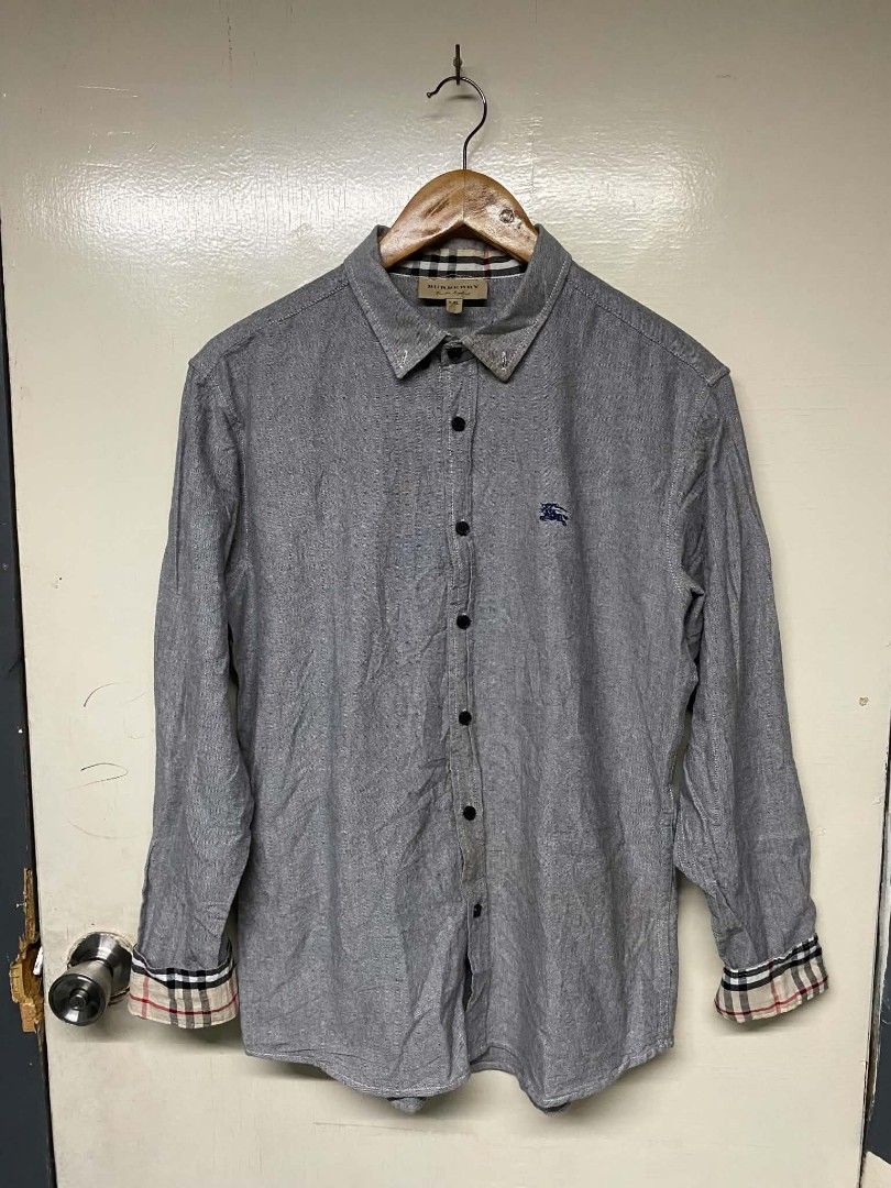 Burberry Men's Button Down Shirt XXL (Category: Formal Shirts) located in Pasig City. Submitted by jstnisidor81288 (Listing ID 1464235533, Image 1). Description: - Authentic Grey Burberry Button Down Shirt - Size: XXL - Classic Burberry check lining inside collar and cuffs - Embroidered Burberry logo on chest.