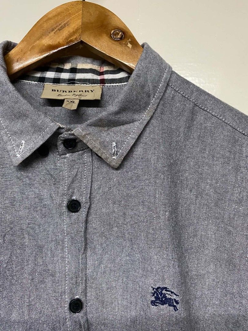 Burberry Men's Button Down Shirt XXL (Category: Formal Shirts) located in Pasig City. Submitted by jstnisidor81288 (Listing ID 1464235533, Image 3). Description: - Authentic Grey Burberry Button Down Shirt - Size: XXL - Classic Burberry check lining inside collar and cuffs - Embroidered Burberry logo on chest.