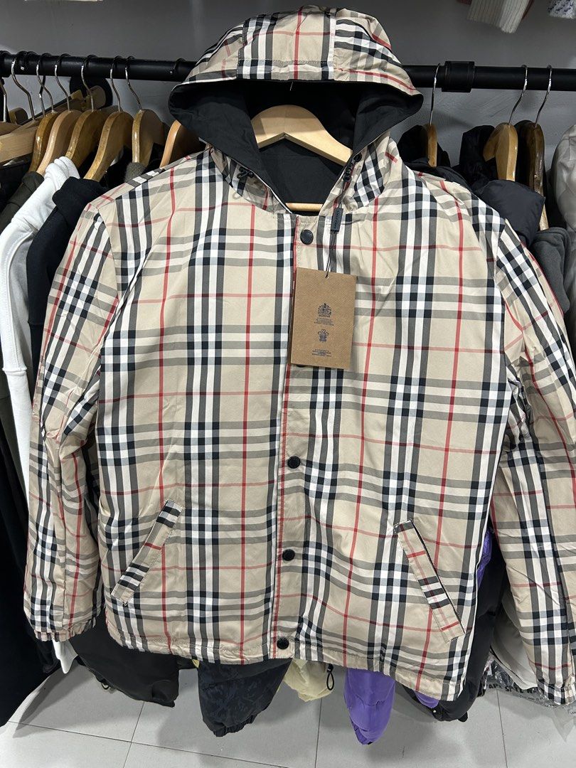 Burberry Reversible Check Hooded Jacket (Category: Luxury Apparel) located in Manila. Submitted by bodegabodega (Listing ID 1464170386, Image 2). Description: - Burberry Reversible Jacket - Two stylish sides: classic black with knight logo OR iconic Burberry check pattern - Hooded design for added style and protection - Secure button closure - Two functional front pockets on the black side - Perfect for versatile styling options Burberry London R