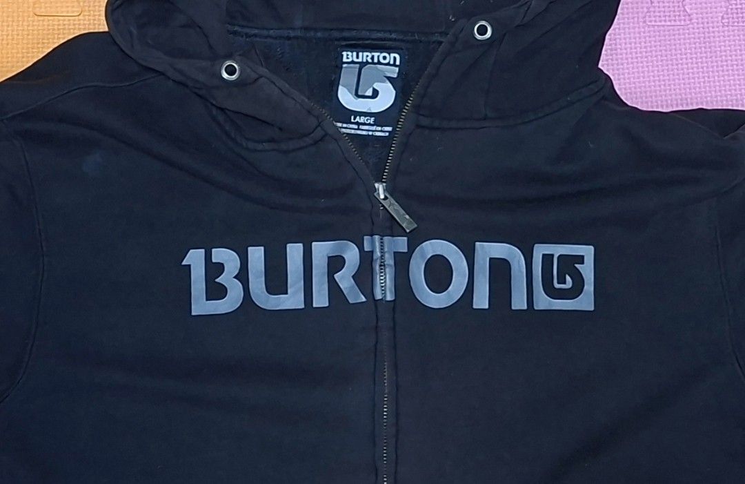 Burton Black Zip-Up Hoodie (Category: Hoodies) located in Manila. Submitted by declutrredgoods (Listing ID 1464284256, Image 2). Description: - Black Burton zip-up hoodie - Size: Large - Features iconic Burton logo on the front - Hooded design with full zip closure - Two convenient front pockets - Ribbed cuffs and hem for a snug fit.