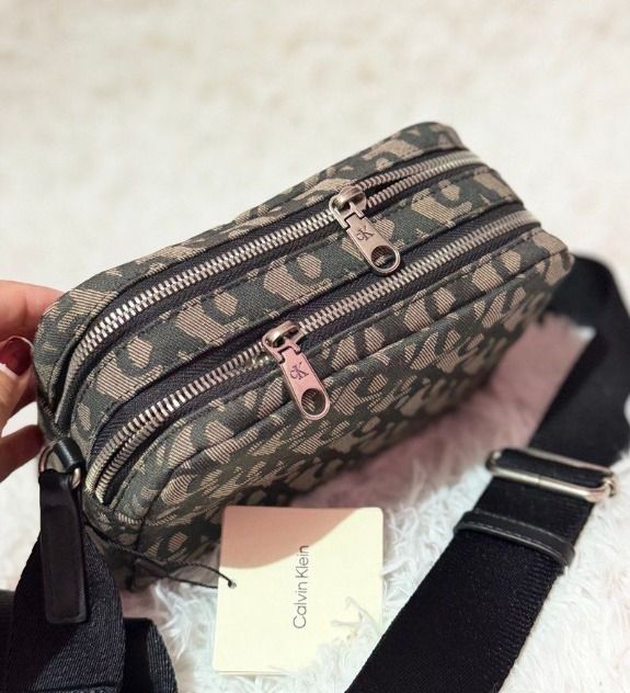 Calvin Klein Monogram Camera Bag (Brown) (Category: Cross-body Bags) located in Nabua. Submitted by jjtampz192013 (Listing ID 1464184143, Image 2). Description: Calvin Klein Monogram Camera Bag - Brown New Arrival from CANADA � Authentic Calvin Klein � Adjustable strap � Lightweight & perfect for everyday use .
