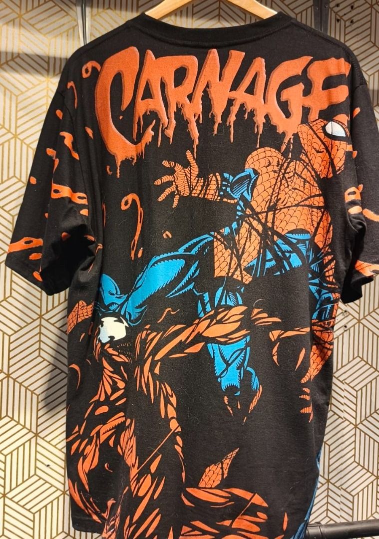 Carnage Vs Spider Man AOP (23x31) (Category: Shirts) located in Manila. Submitted by eastbluevtg (Listing ID 1464205708, Image 1). Description: - Black t-shirt with a striking, all-over print of a fiery character. - Features a vibrant, comic book-style graphic with intense details and orange/yellow flames. - Classic short sleeves and crew neck design. - Perfect for fans of graphic tees and bold, unique statement pieces. - A guaranteed head-turner