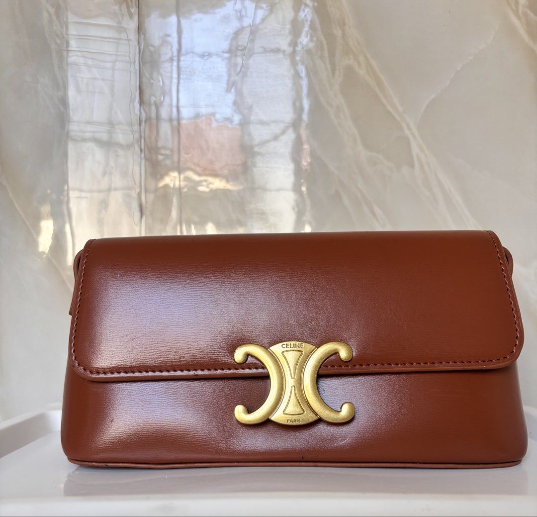 Celine Triomphe Shoulder Bag in Brown Leather (Category: Luxury Bags & Wallets) located in Caloocan City. Submitted by lovelj_2026 (Listing ID 1464251096, Image 2). Description: Japan preloved bags Still in good condition Minimal sign of usage Please manage your expectations. - brown leather Celine shoulder bag - Iconic gold-tone Triomphe clasp - Interior slip pocket for essentials - Adjustable strap for comfortable wear - Timeless and versatile 