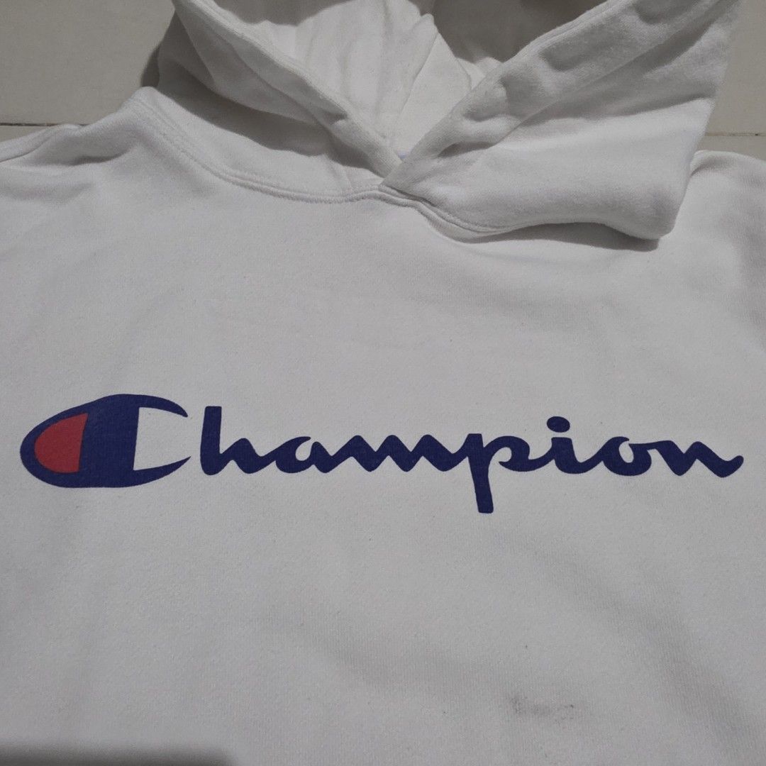 Champion White Hoodie with Vertical Logo (Category: Hoodies) located in Quezon City. Submitted by kick_mnl (Listing ID 1464164670, Image 2). Description: - Classic white Champion hoodie - Features iconic vertical Champion logo in blue and red - Convenient front pocket - Approximate measurements: 20" chest, 21" length - Ideal for everyday casual wear.