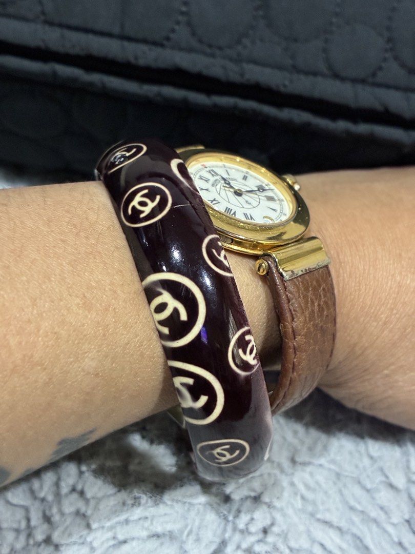 Chanel Bangle Bracelet (Category: Luxury Accessories) located in Manila. Submitted by cellymeji060371 (Listing ID 1427962784, Image 3). Description: Elegant bangle bracelet featuring the iconic Chanel logo. The bracelet has a dark burgundy base with the Chanel logo in a contrasting cream color. It is a wide, rounded design. The bracelet is shown worn on a wrist..