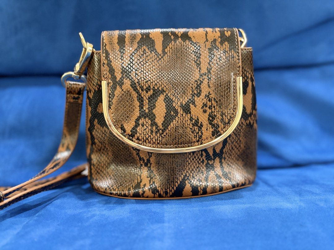 Charles and Keith snake skin pattern bag (Category: Cross-body Bags) located in Naga. Submitted by grand_trehh (Listing ID 1464171996, Image 1). Description: no issue like new .