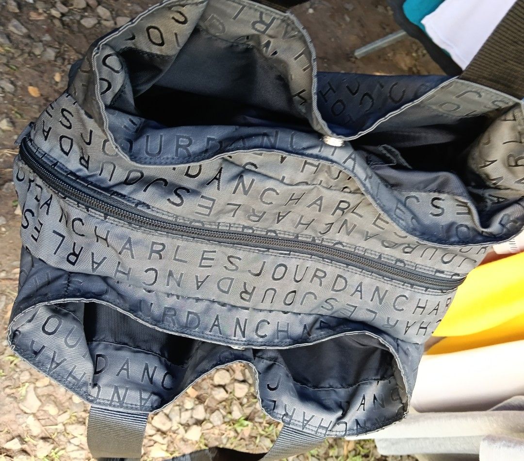 Charles Jourdan Paris Tote Bag (Category: Tote Bags) located in Antipolo. Submitted by vastgem_4c8da8 (Listing ID 1464181123, Image 3). Description: - Stylish grey tote bag with all-over Charles Jourdan Paris logo print. - Secure zipper closure at the top. - Interior features a zippered pocket and a slip pocket for organization. - Sturdy handles for comfortable carrying. - Spacious and practical design, perfect for everyday use or travel..