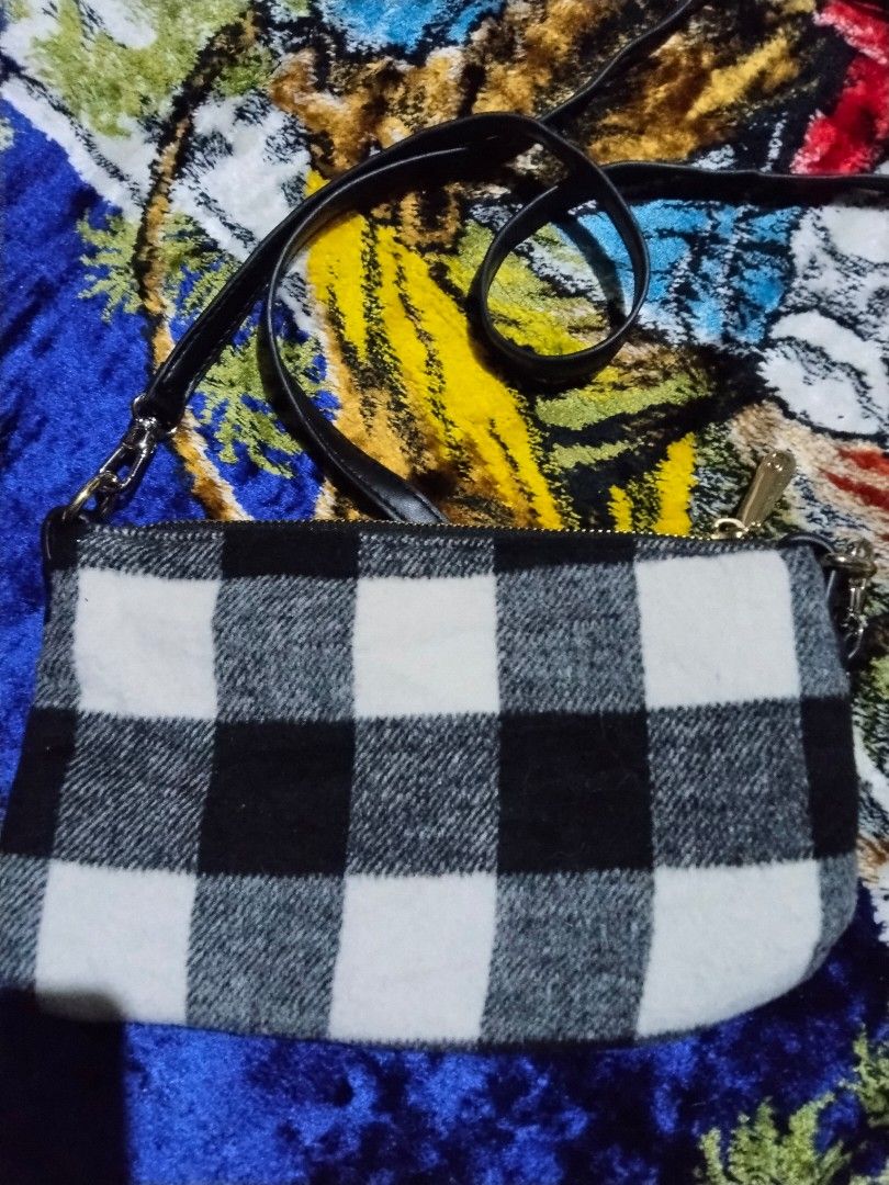 Checkered Plaid Crossbody Bag (Category: Shoulder Bags) located in Mabalacat. Submitted by al_amin_thrift (Listing ID 1464244543, Image 2). Description: Checkered Plaid Crossbody Bag — Black / White / Gray Style: Slim, sleek crossbody / clutch bag Pattern: Classic buffalo plaid — black, white & gray Material: Soft wool‑blend fabric body + smooth black faux leather trim & strap Hardware: Shiny gold‑tone — zipper pull with signature “C” emblem, rin