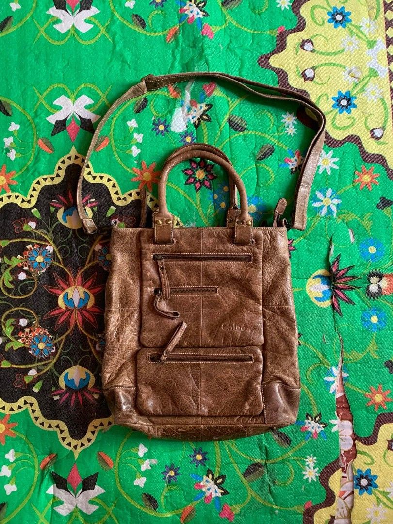 Chloe Brown Distressed Leather Tote Bag (Category: Tote Bags) located in Dipolog. Submitted by en.en_mdkh (Listing ID 1464201026, Image 3). Description: - Authentic Chloe brown leather tote bag - Stylish distressed leather finish - Multiple functional pockets and zippers on the front - Versatile carrying options: top handles and a longer strap - Ideal for everyday use and carrying essentials.