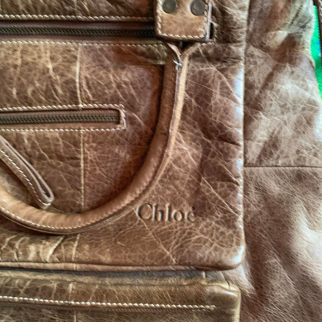 Chloe Brown Distressed Leather Tote Bag (Category: Tote Bags) located in Dipolog. Submitted by en.en_mdkh (Listing ID 1464201026, Image 2). Description: - Authentic Chloe brown leather tote bag - Stylish distressed leather finish - Multiple functional pockets and zippers on the front - Versatile carrying options: top handles and a longer strap - Ideal for everyday use and carrying essentials.