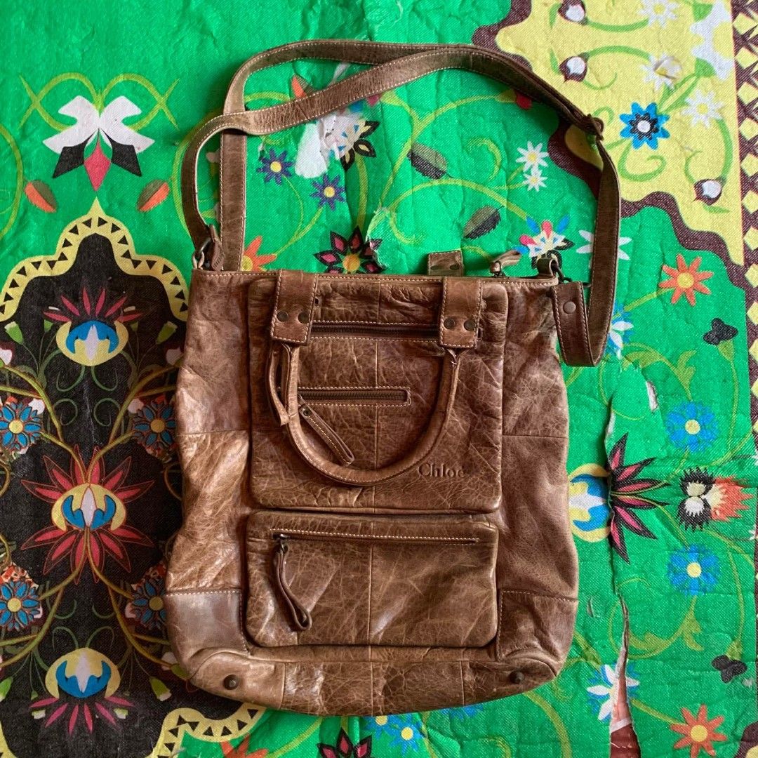 Chloe Brown Distressed Leather Tote Bag (Category: Tote Bags) located in Dipolog. Submitted by en.en_mdkh (Listing ID 1464201026, Image 1). Description: - Authentic Chloe brown leather tote bag - Stylish distressed leather finish - Multiple functional pockets and zippers on the front - Versatile carrying options: top handles and a longer strap - Ideal for everyday use and carrying essentials.
