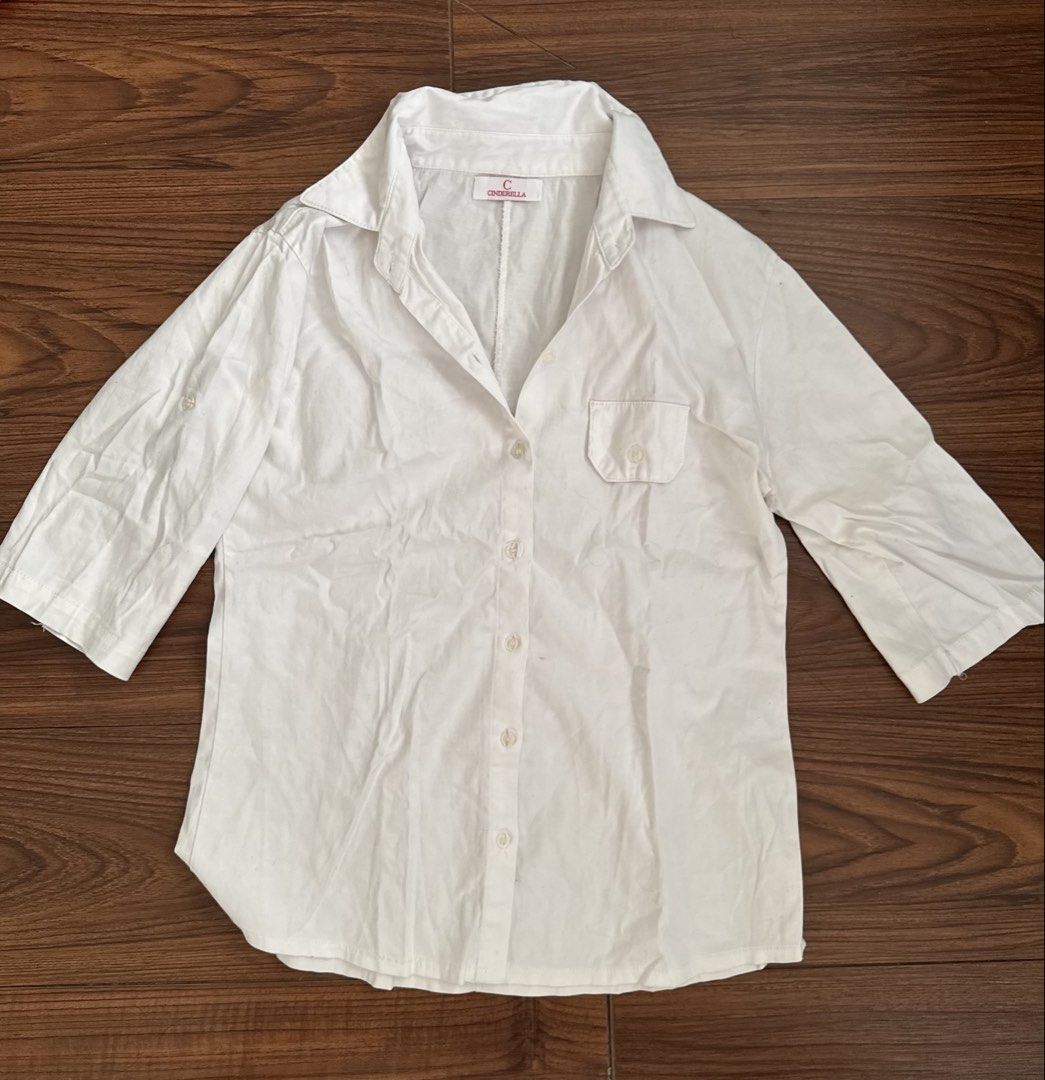 Cinderella White Button-Up Shirt (Category: Shirts) located in Rizal. Submitted by thrifty.mom (Listing ID 1464279706, Image 1). Description: - Brand: Cinderella - Color: White - Sleeve Length: Three-quarter sleeves with button tab for rolled cuffs - Pockets: Single chest pocket - Measurements: Pit to pit approx. 21 inches, Length approx. 25 inches - Style: Casual wear.