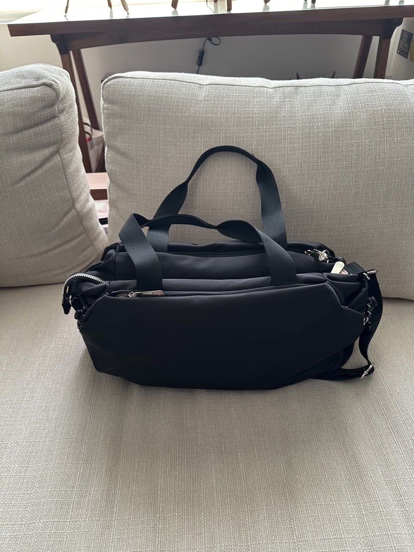 CLN Black Nylon Duffle Bag with Shoulder Strap (Category: Shoulder Bags) located in Manila. Submitted by qualitypreluvd (Listing ID 1464157587, Image 2). Description: - CLN black nylon duffle bag - Top handles and detachable shoulder strap - Multiple zippered compartments for organization - Light pinkish-beige interior lining - Small CLN logo on the front - Includes a cute beaded charm on zipper pull - Ideal for travel or everyday use - no flaws,