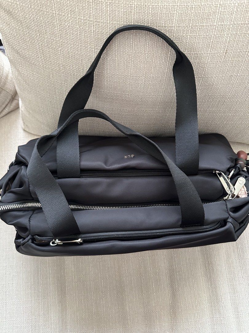 CLN Black Nylon Duffle Bag with Shoulder Strap (Category: Shoulder Bags) located in Manila. Submitted by qualitypreluvd (Listing ID 1464157587, Image 3). Description: - CLN black nylon duffle bag - Top handles and detachable shoulder strap - Multiple zippered compartments for organization - Light pinkish-beige interior lining - Small CLN logo on the front - Includes a cute beaded charm on zipper pull - Ideal for travel or everyday use - no flaws,