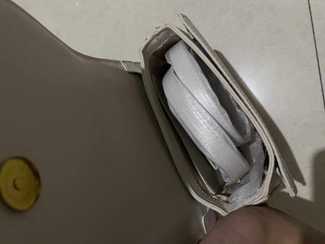 CLN White Handbag with Dust Bag (Category: Shoulder Bags) located in Taguig. Submitted by _lly.wyn (Listing ID 1464199097, Image 3). Description: - Brand new white CLN handbag - Comes with original dust bag and packaging - Features a gold CLN logo on the front - Strap is included inside the bag - Recently purchased.