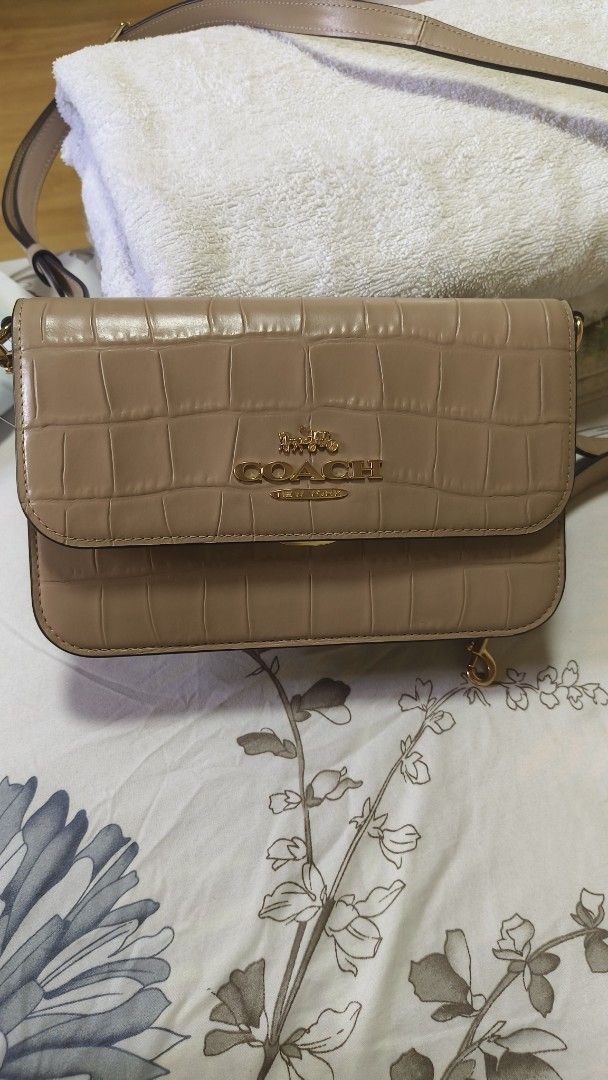 Coach Brynn two way (Category: Luxury Bags & Wallets) located in Rizal. Submitted by ortegaalex06291 (Listing ID 1464235855, Image 1). Description: complete like new used twice only - Authentic Coach crossbody bag - Elegant beige color - Luxurious croc-embossed leather exterior - Stylish gold hardware - Detachable and adjustable strap for versatile wear - Interior features Coach New York leather tag with serial number - Includes original Coach ha