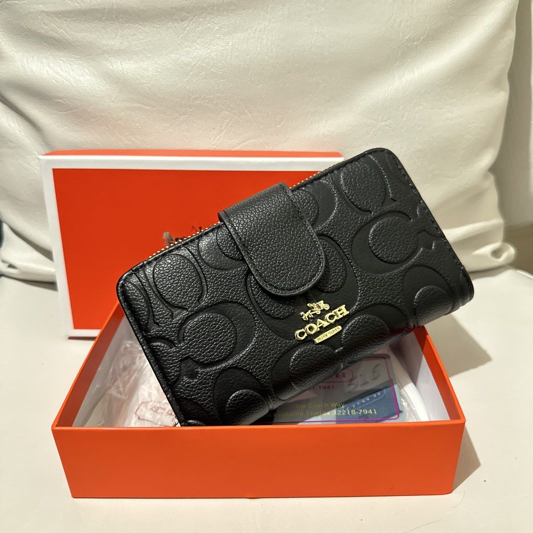 Coach Embossed Signature Wallet Black (Category: Wallets & Card holders) located in Marikina City. Submitted by bry_lei26 (Listing ID 1464181670, Image 1). Description: - Coach bi-fold wallet - Color: Black with all-over embossed signature C pattern - Hardware: Gold details - Closure: Snap closure with zip-around coin pocket - Interior: Card slots and clear ID window - Includes: Coach box - Origin: Made in Vietnam.