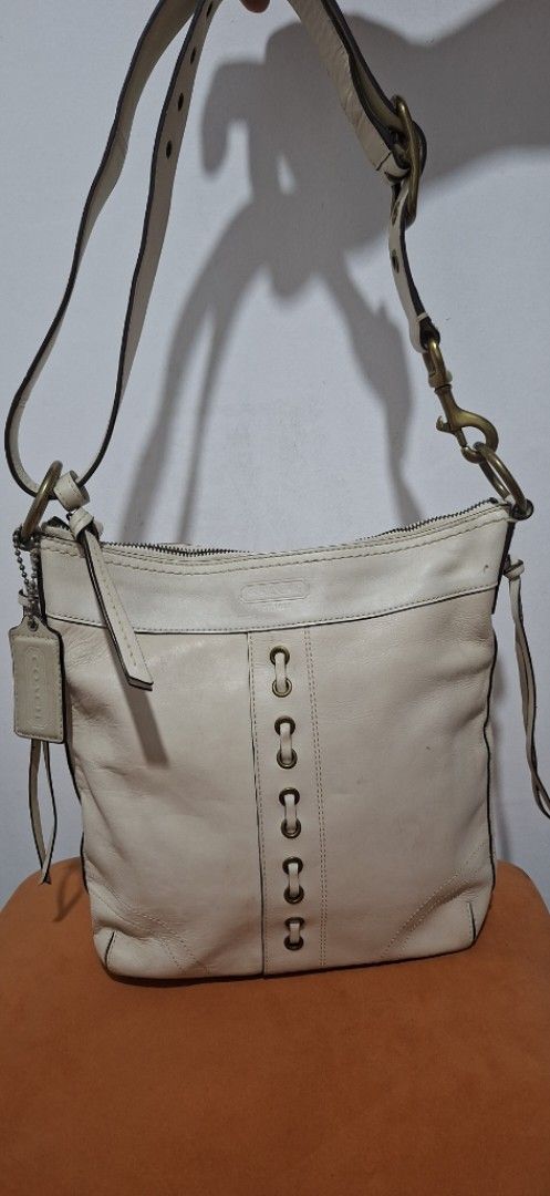 Coach Leather Hobo Bag (Category: Luxury Bags & Wallets) located in Santa Rosa. Submitted by royyumireon27 (Listing ID 1464230028, Image 1). Description: - Cream colored genuine leather Coach hobo bag - Unique grommet detail on the front - Adjustable strap with classic brass hardware - Secure zipper closure - Comes with original Coach hangtag - Ideal for everyday wear and versatile styling.