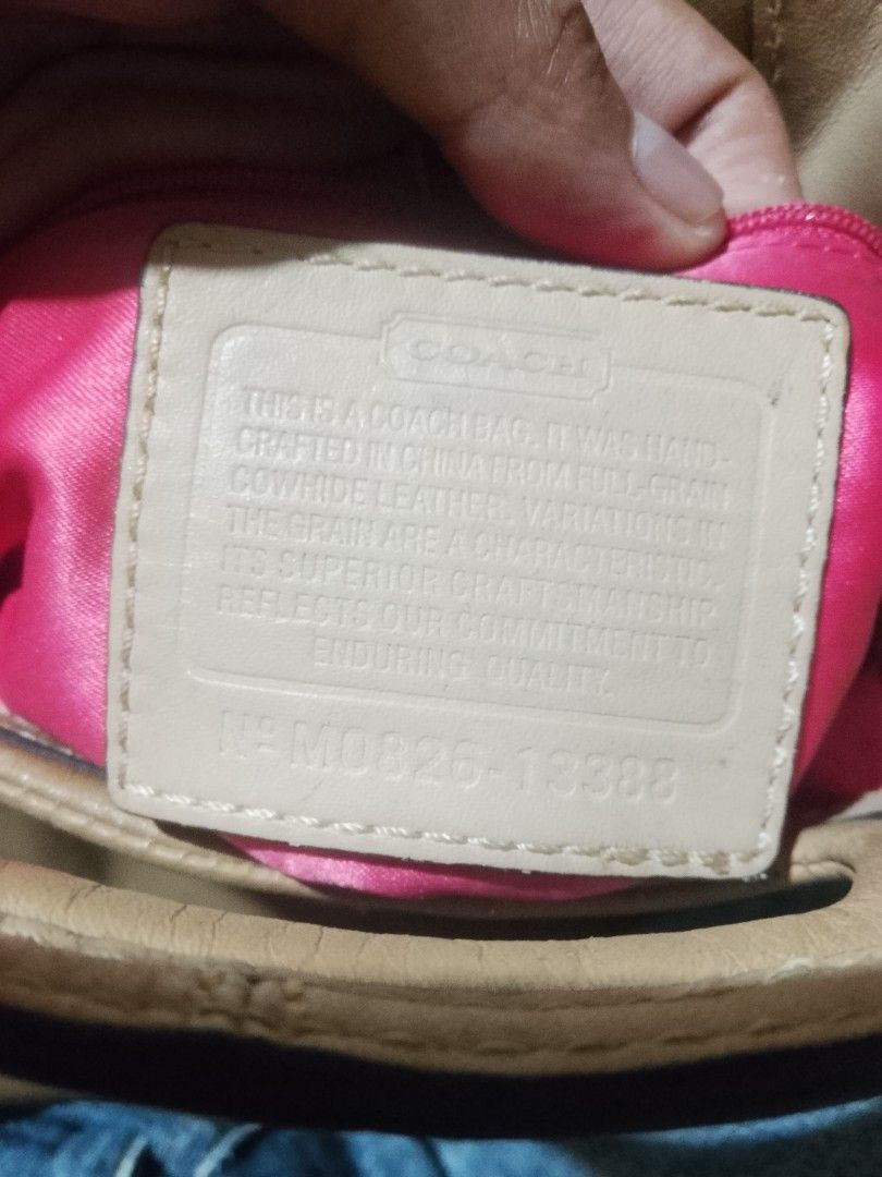 Coach Leather Shoulder Bag (Category: Luxury Bags & Wallets) located in Quezon City. Submitted by theoneshop1 (Listing ID 1464269210, Image 2). Description: - Authentic Coach crossbody bag in tan leather. - Features a stylish and secure zipper closure. - Interior lined with a fun, bright pink fabric. - Crafted from genuine full-grain cowhide leather (China). - Natural grain variations are characteristic of the material. - Serial number: N° M0826-