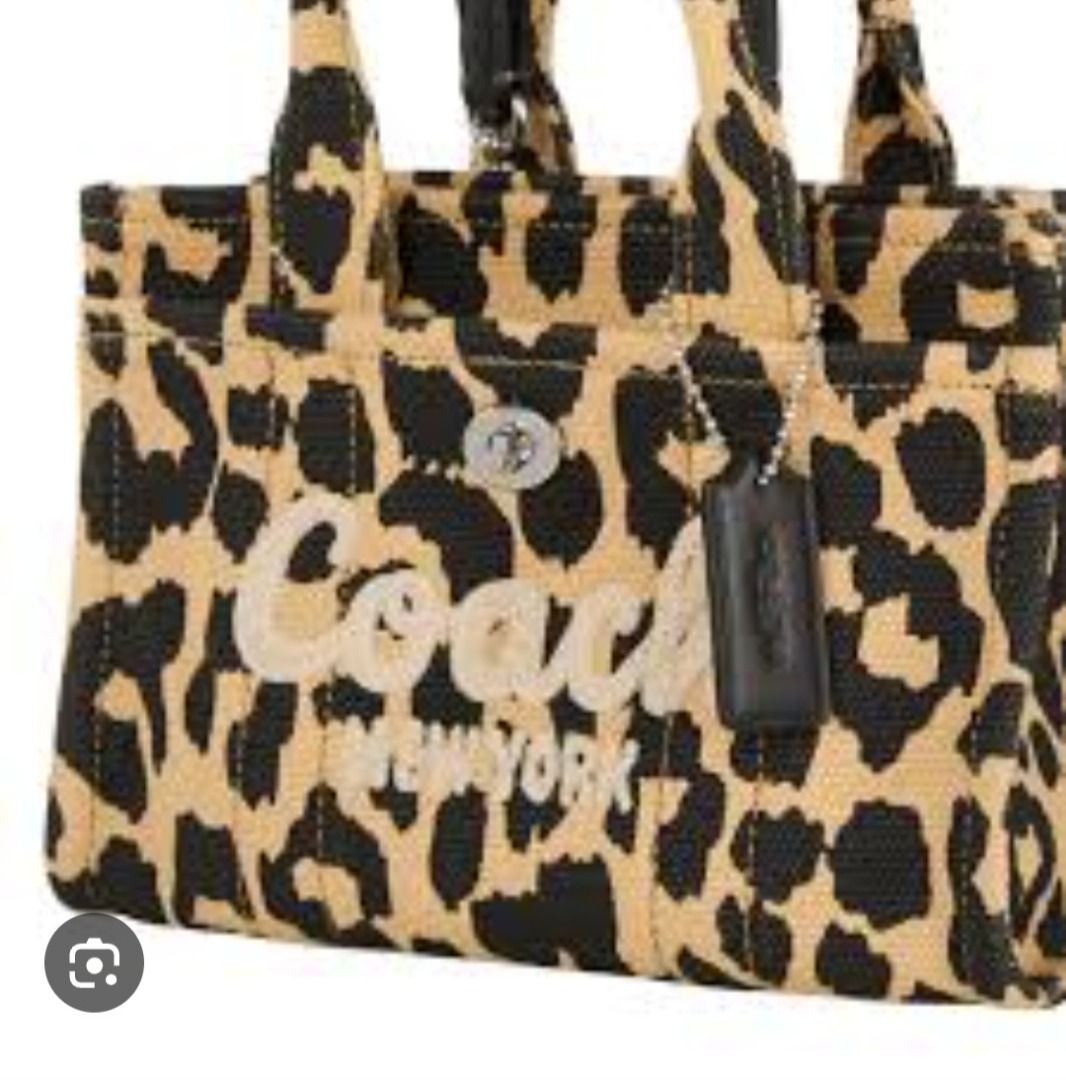 Coach Leopard Print Tote Bag With Strap (Category: Tote Bags) located in Manila. Submitted by katkween23 (Listing ID 1464225787, Image 3). Description: - Cute Coach tote bag - Fun all-over leopard print - Embroidered Coach New York logo on front - Top handles - Detachable crossbody strap - Small leather tag attached - Great for everyday use.