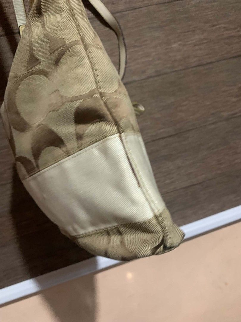 Coach Monogram Canvas Hobo Bag (Category: Luxury Bags & Wallets) located in Aliaga. Submitted by akishaoshop2010. (Listing ID 1464138810, Image 3). Description: - Coach hobo bag in signature monogram canvas - Beige and brown colorway with a white stripe detail - Genuine leather trim and strap - Silver hardware - Secure zipper closure - Perfect for everyday use - Ample interior space.