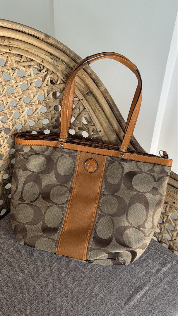 Coach Monogram Canvas Leather Trim Tote Bag (Category: Luxury Bags & Wallets) located in Batangas. Submitted by prelove.kk (Listing ID 1464219640, Image 1). Description: - Coach monogram canvas tote bag - Tan leather trim and handles - Zipper closure - Interior zippered and slip pockets - Minor marks on canvas - Wear on leather handles - Great everyday bag.
