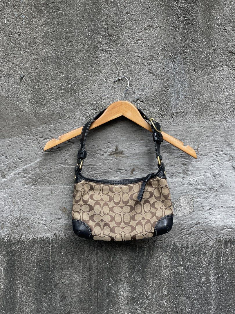Coach Monogram Canvas Leather Trim Shoulder Bag (Category: Luxury Bags & Wallets) located in Makati City. Submitted by christian_g (Listing ID 1464249058, Image 1). Description: - Authentic Coach shoulder bag - Classic monogram canvas with black leather trim - Gold hardware details - Secure zipper closure - Interior: 1 zippered pocket, 1 slip pocket - Serial number visible in photos - Ideal for everyday use.