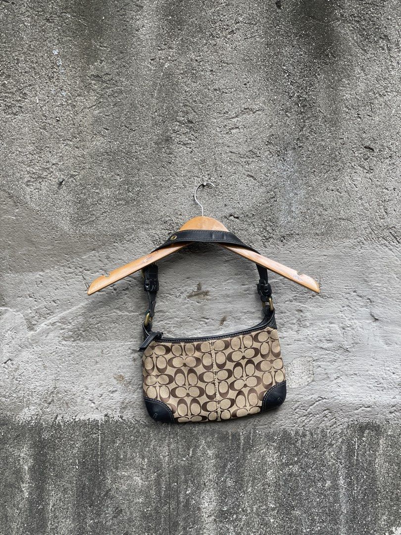 Coach Monogram Canvas Leather Trim Shoulder Bag (Category: Luxury Bags & Wallets) located in Makati City. Submitted by christian_g (Listing ID 1464249058, Image 2). Description: - Authentic Coach shoulder bag - Classic monogram canvas with black leather trim - Gold hardware details - Secure zipper closure - Interior: 1 zippered pocket, 1 slip pocket - Serial number visible in photos - Ideal for everyday use.