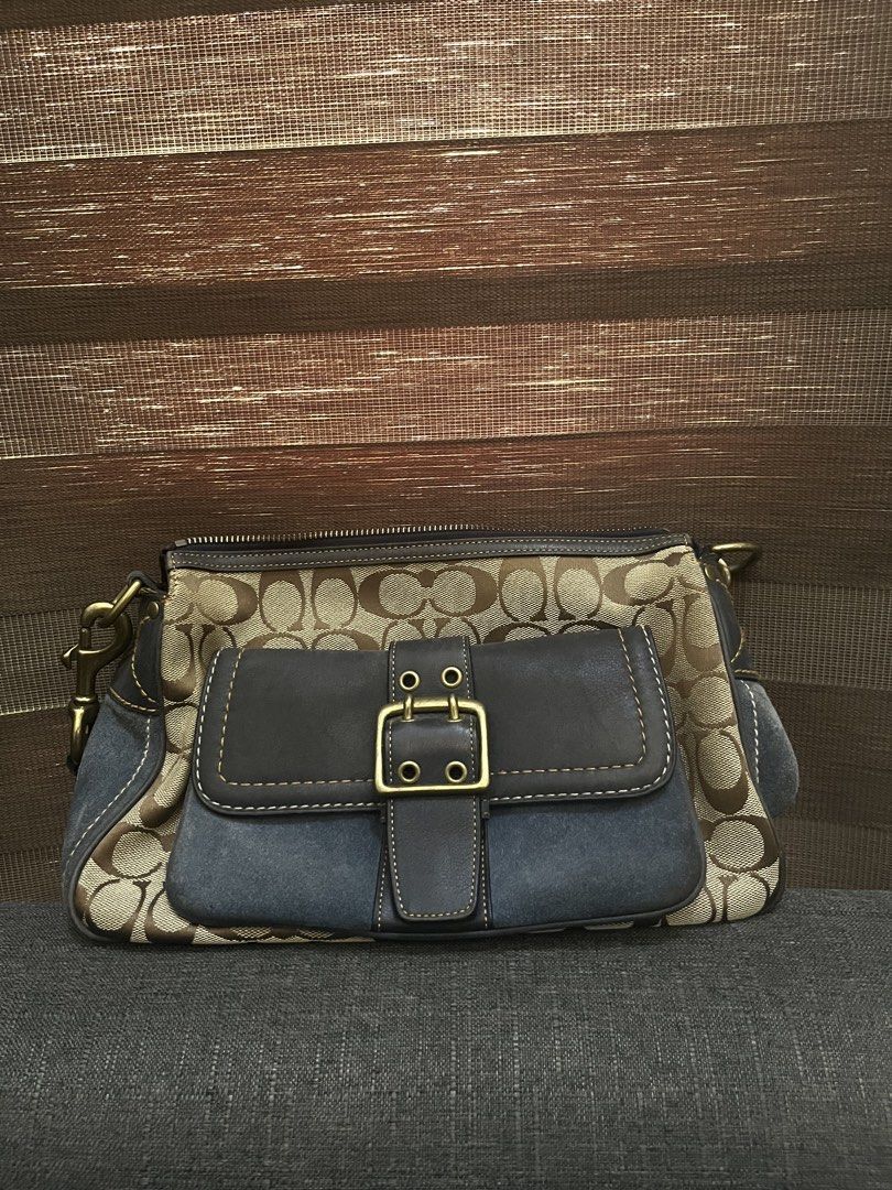 Coach Monogram Shoulder Bag (Category: Luxury Bags & Wallets) located in Guiguinto. Submitted by guwiiii (Listing ID 1464306145, Image 3). Description: Classic Coach monogram shoulder bag with dark blue suede accents. Features signature C pattern, leather trim, brass hardware, and top zipper closure. Includes interior serial number. Perfect for everyday use. Vintage Design No Hangtag 100% Authentic ₱7,000 (STILL NEGOTIABLE) Location: Guiguinto Bu