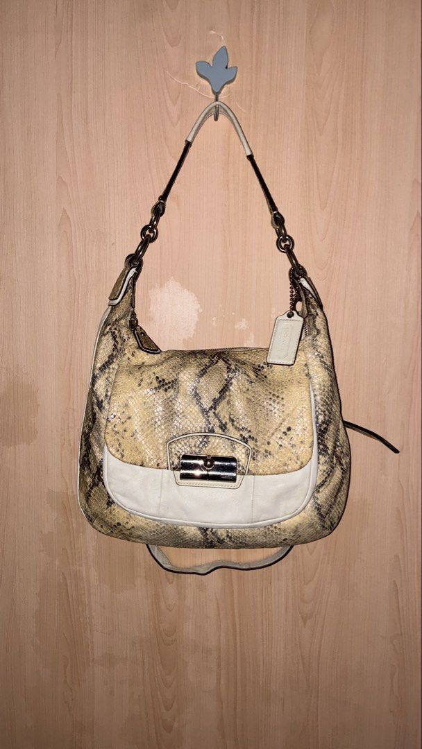 Coach Python Embossed Leather Hobo Shoulder Bag (Category: Luxury Bags & Wallets) located in Placer. Submitted by talaalond61563 (Listing ID 1464287929, Image 1). Description: - Authentic Coach hobo bag - Unique python embossed pattern - Cream leather trim and silver hardware - Stylish chain detail on the strap - Includes original Coach hangtag - Spacious interior for essentials - Ideal for everyday use.