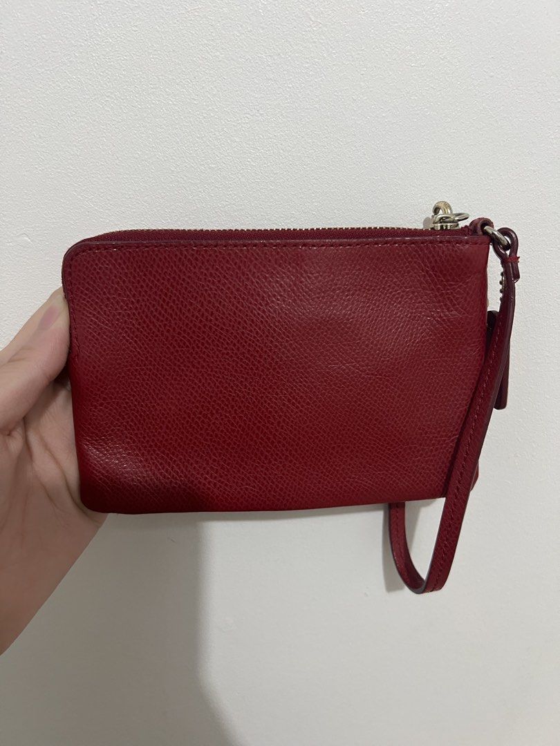 Coach red wristlet wallet (Category: Wallets & Card holders) located in Paranaque City. Submitted by enchanteboutique (Listing ID 1464308188, Image 2). Description: In good condition with signs of use on hardware .