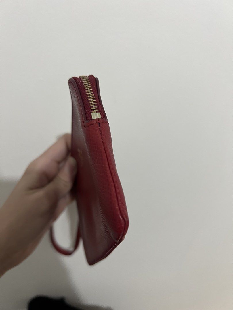 Coach red wristlet wallet (Category: Wallets & Card holders) located in Paranaque City. Submitted by enchanteboutique (Listing ID 1464308188, Image 3). Description: In good condition with signs of use on hardware .