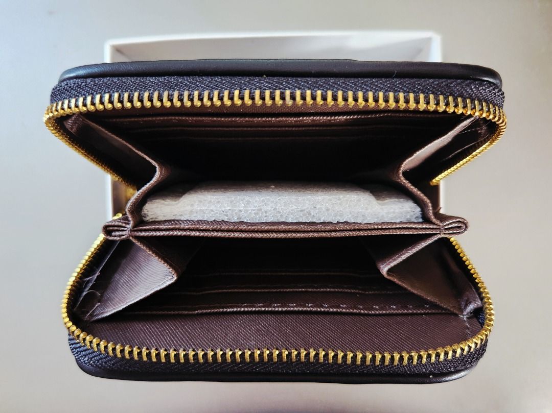 COACH Signature Zip Around Wallet (Category: Wallets & Card holders) located in Taguig. Submitted by aip12 (Listing ID 1464208986, Image 3). Description: - Width: 5", Height: 3.5" - Authentic Coach zip around wallet - Signature C pattern in black and grey - Black leather trim and gold hardware - Multiple interior card slots - Interior zip pocket for coins or receipts - Comes with original Coach box - Ideal for keeping your essentials organized Pl