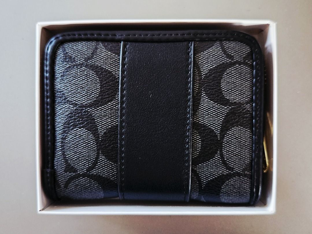 COACH Signature Zip Around Wallet (Category: Wallets & Card holders) located in Taguig. Submitted by aip12 (Listing ID 1464208986, Image 2). Description: - Width: 5", Height: 3.5" - Authentic Coach zip around wallet - Signature C pattern in black and grey - Black leather trim and gold hardware - Multiple interior card slots - Interior zip pocket for coins or receipts - Comes with original Coach box - Ideal for keeping your essentials organized Pl