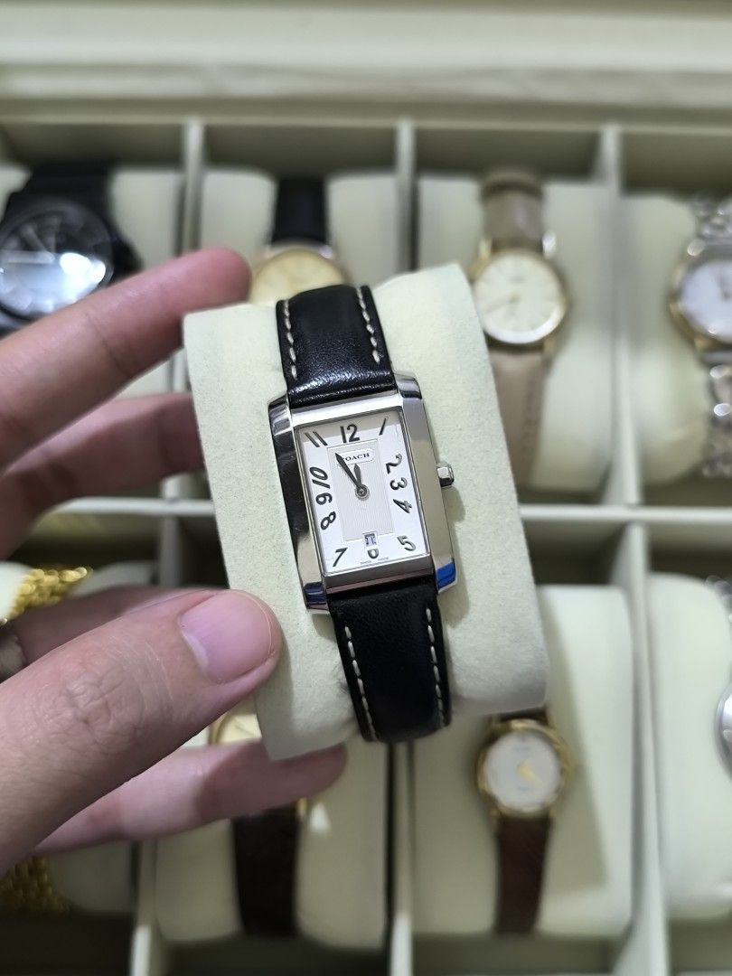 COACH Swiss Made Vintage Watch (Category: Women's Watches) located in Pasig City. Submitted by thevintagechroniclefindsph (Listing ID 1464211627, Image 1). Description: Classic rectangular/tank-style Coach dress watch with black leather strap. Silver/white dial with Arabic numerals and date display at 6 o'clock. WATCH DETAILS: Brand: COACH Ref./Model: 7.142.232 Swiss Made Quartz movement Stainless steel case Rectangular case Date display Black le